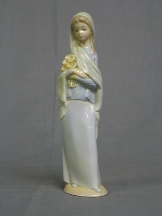 A Lladro figure of a standing girl with flowers, the base marked Lladro and impressed 4650 9"