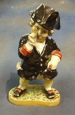An 18th/19th Century Staffordshire jug of "Toby Philpot" taking snuff, raised on an oval base (f and r) 14"