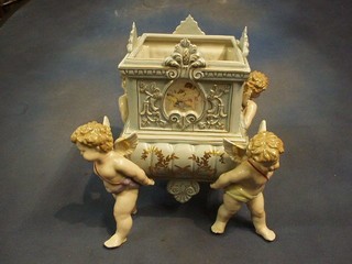 A 19th Century style porcelain jardiniere supported by 4 winged cherubs 11"