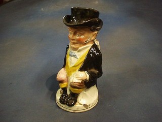 A 19th Century Staffordshire Toby jug in the form of a top hatted, seated gentleman 11" (base holed)