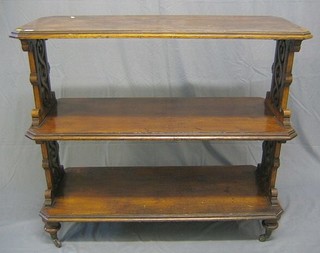 A Victorian aesthetic movement lozenge shaped 3 tier buffet, pierced panels to the sides, raised on bun feet, 48"
