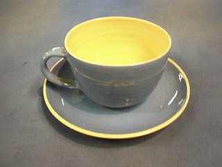 A large 1950's blue glazed pottery cup and saucer, the interior base painted a pig