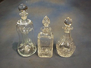 A square cut glass spirit decanter, a pinched decanter, 2 cut glass decanters an etched glass beerstein and a glass vase
