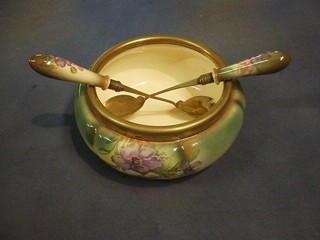 An Edwardian green glazed salad bowl with silver plated mounts and a pair of salad servers