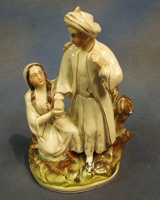 A 19th Century Staffordshire figure "Hester and King Abraham of the Persians" on an oval base (chip to Kings headress) 11"