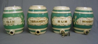 4 19th Century blue and gilt banded spirit barrels marked Gin (interior cracked and with chip to rim), Brandy (crazed and cracked), Rum (crazed and chip to rim), Whiskey (crazed and cracked)