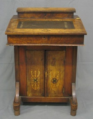 A Victorian inlaid walnutwood Davenport desk, the back with hinged stationery box, the base fitted a cupboard, 21"