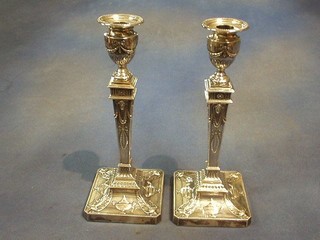 A pair of Edwardian embossed silver Adam style candlesticks with detachable sconces, London 1901, 12"