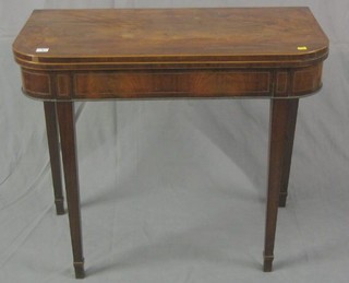 A Georgian mahogany D shaped card table with satinwood inlay, raised on square tapering supports ending in spade feet 35"