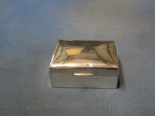 A plain silver cigarette box with hinged lid, London 1921, 5"