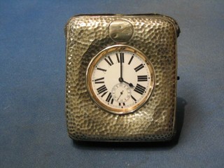 An Edwardian planished silver travelling watch case containing a Goliath style pocket watch 3" (winder f)
