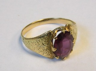 A lady's gold dress ring with oval cut pink stone