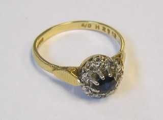 A lady's 18ct gold dress ring set a sapphire surrounded by diamonds