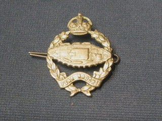 A Tank Corps cap badge (tank in reverse)