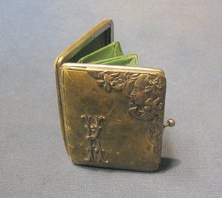 An Art Nouveau green leather purse with embossed mounts in the form of head and shoulders of lady