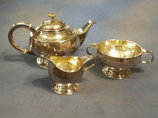 A 3 piece "unmarked" silver tea service of circular form with teapot, twin handled sugar bowl and cream jug, raised on spreading feet 40 ozs