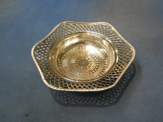 A circular pierced silver plated straining dish