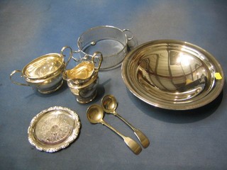 A circular silver plated bowl, a pierced silver plated dish frame, a small silver dish, silver plated twin handled sugar bowl and cream jug and 2 silver plated fiddle pattern sauce ladles