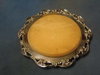 A circular pierced silver plated bread board holder