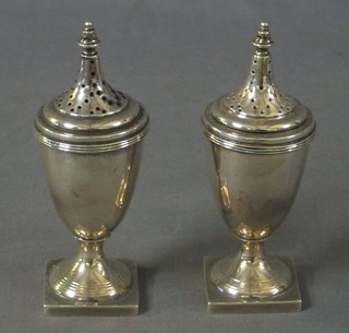 A pair of Georgian style silver pepperettes Birmingham 1911