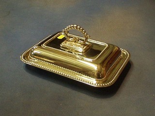 A rectangular silver plated entree dish with bead work border