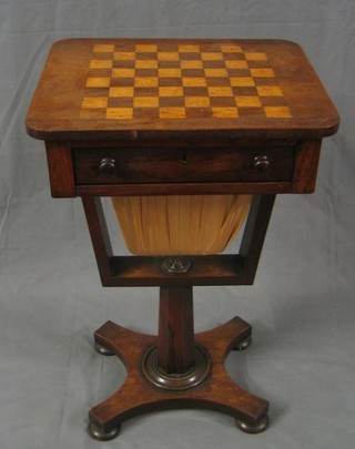 A William IV rosewood work table, the top inlaid a chess board fitted a drawer and with deep basket, raised on a chamfered column with triform base and bun feet 18"
