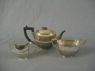 An oval silver plated 3 piece tea service with  teapot with twin handled sugar bowl, and cream jug with demi-reeded decoration