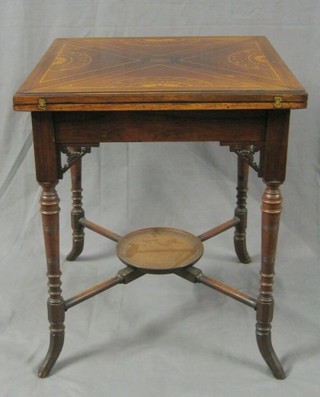 A Victorian inlaid rosewood envelope card table, the base fitted a drawer and raised on turned supports with circular undertier 22"