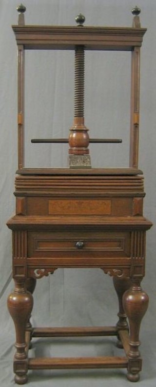 An 18th Century oak book press on a somewhat later stand, fitted a drawer, raised on bulbous turned supports with box framed stretcher 25"