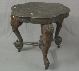 An Eastern carved hardwood circular occasional table  raised on elephant head supports 26"