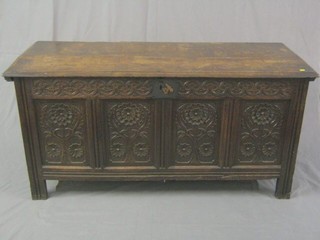 An 18th Century carved oak coffer of panelled construction with hinged lid 61"