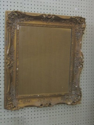 A rectangular plate mirror contained in a decorative gilt frame  21"