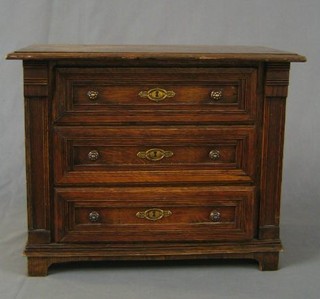 A Continental oak apprentice chest of 3 long drawers, raised on bracket feet 14"