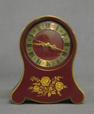 A Le Coutre musical alarm clock contained in an arch shaped red painted metal case together with 1 other