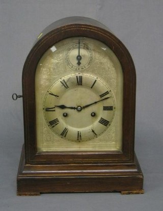 An Edwardian 8 day striking bracket clock contained in an arched mahogany case