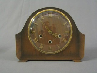 A 1950's 8 day chiming mantel clock with Roman numerals contained in a walnut arched case