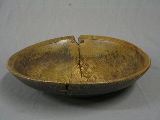 An antique circular wooden dish (split and repaired) 18"