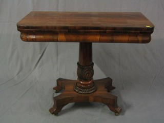 A William IV D shaped rosewood card table raised on a carved turned column and tripod base 36"