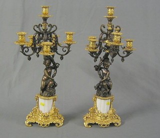 A pair of 20th Century bronze and gilt metal 5 light candelabrums supported by cherubs 22"