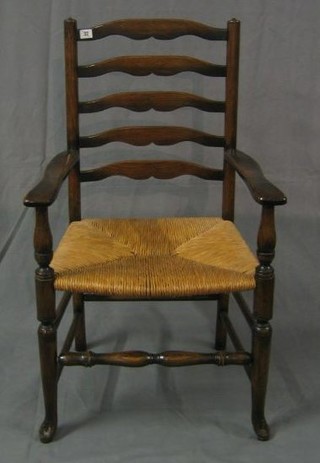 A pair of elm Lancashire ladder back carver chairs with woven rush seats