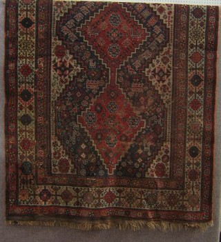 A 19th Century Caucasian rug with 3 diamond shaped panels  to the centre within multi-row borders 85" x 57"