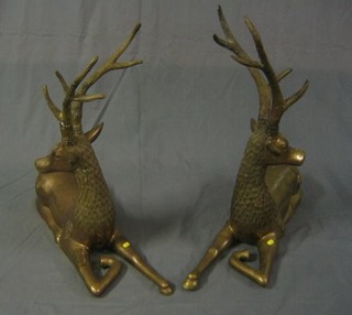 A pair of gilt bronze figures of seated stags 31"