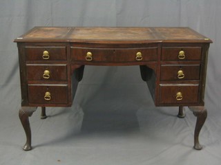 A Chippendale style bow front writing table fitted 1 long and 6 short drawers, raised on cabriole supports 48"