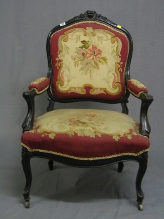 An Edwardian ebonised show frame open arm chair with Berlin wool work seat and a matching standard chair