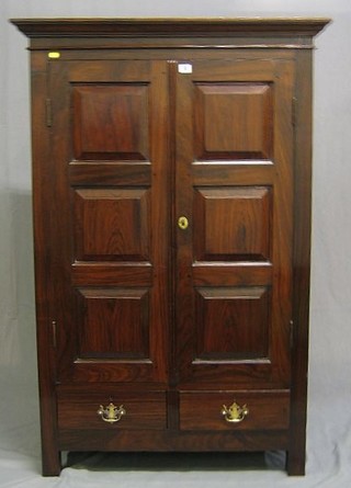 A 19th Century Eastern hardwood cabinet  enclosed by panelled doors, the base fitted a drawer 37"