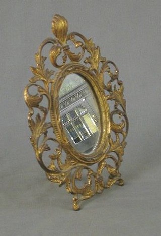 A 19th Century oval plate mirror contained in a pierced gilt metal easel frame 11"