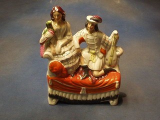 A 19th Century Staffordshire figure group of kneeling Scotsman, Lady and Parrot 11"