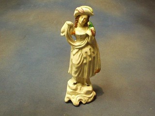 A  19th Century Staffordshire figure of a standing bonnetted lady and parrot 10"