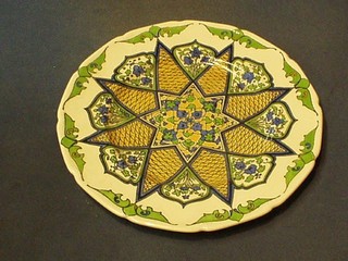 A Royal Doulton plate with green glazed geometric pattern, the base marked 26, 11"
