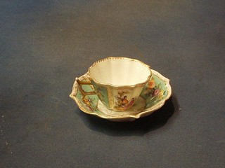 A Dresden style cup and saucer with panelled decoration depicting figures